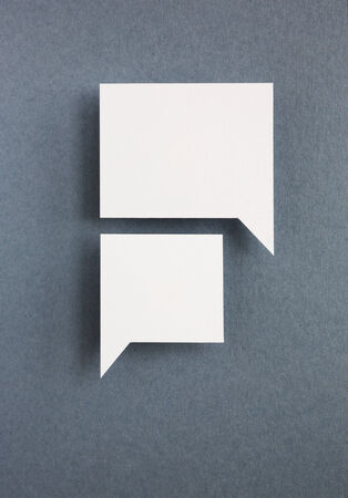 paper speech bubbles on grey backgroundの写真素材