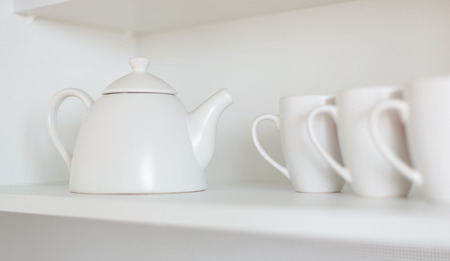 white teapot and cups on the shelfの写真素材