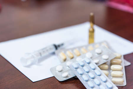 Medicines and doctor's prescription on the table