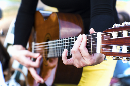 Female guitarist playing guitar outdoor