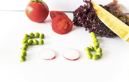 Food writing with green peas and red radish on the isolated background with knife