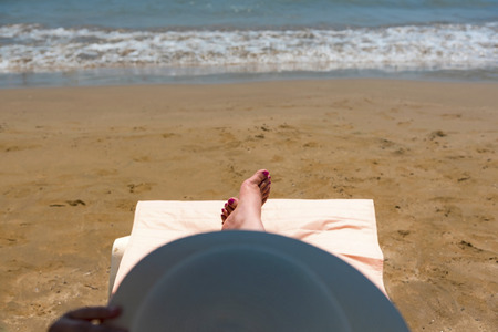 Woman lying on the sunbed near the sea, outdoorsの写真素材