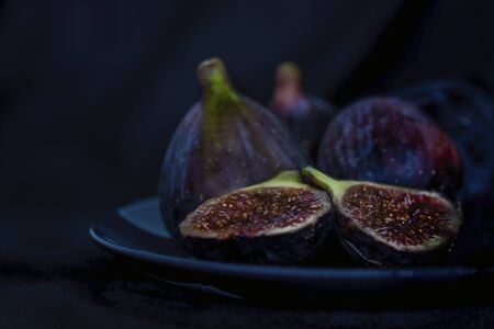 Exotic fig fruits in a blue plate, close up, isolated, still life photographyの写真素材