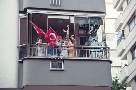 As a result of the Covid-19 people have to celebrate The Commemoration of Atat?rk, Youth and Sports Day from their balconies in Adana-Turkey. 05/19/2019のeditorial素材