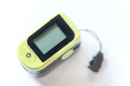Black and green colored pulse oximeter on a white background, isolated, close up