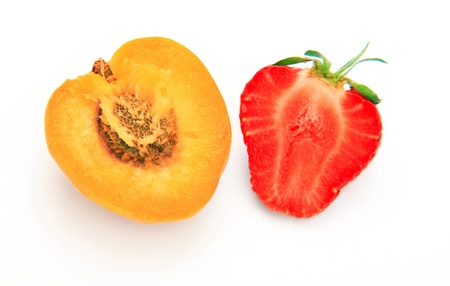 Apricot and strawberry cut open on white background の写真素材