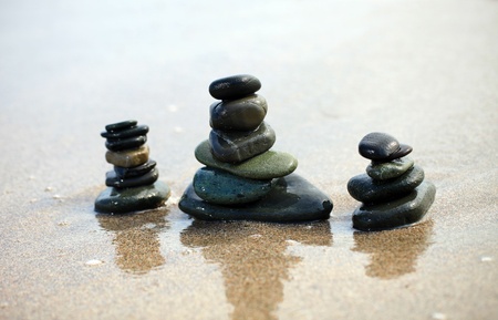 Three stacks of sea pebbles on the beach の写真素材