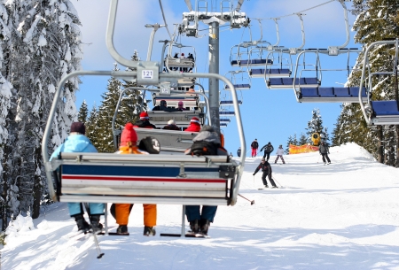 Skiers go on the lift on mountain in Bukovel, Ukraine Skiers go on the lift on mountain in Bukovel, Ukraine
