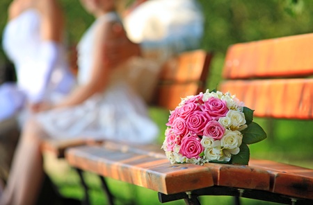 Bridal bouquet on bench in park, image with shallow depth of field, the flowers in focus の写真素材