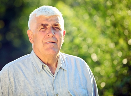 Closeup portrait of a handsome mature man on a sunny day の写真素材