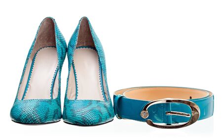 Pair of leather women shoes and belt isolated over white の写真素材