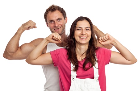 Young couple flexing biceps over white backgrounの写真素材