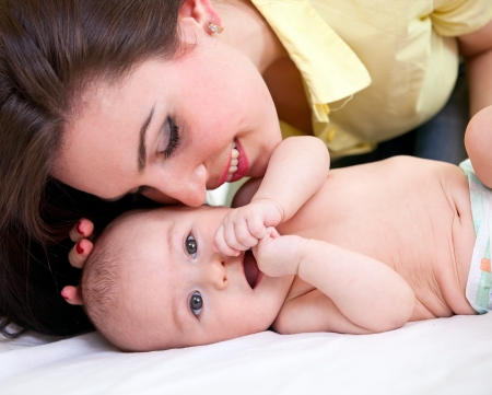 Portrait of young caucasian woman and her three-month old sonの写真素材