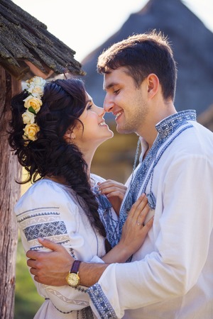 Romantic young couple in Ukrainian style clothes outdoorsの写真素材