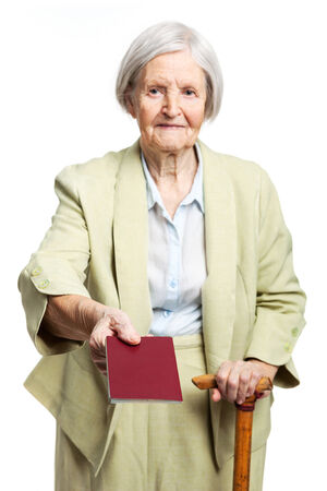 Senior woman giving passport while standing over whiteの写真素材