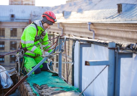 Industrial climber on a roof of a buildingの写真素材