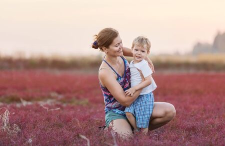 Young woman and her son having fun outdoorsの写真素材