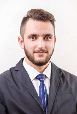 Caucasian young man smiling over white backgroundの写真素材