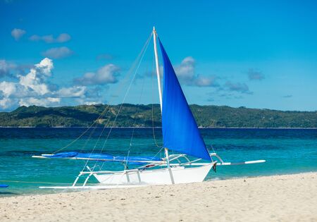 Boat docked on sand beach, Boracay island, Philippinesの写真素材