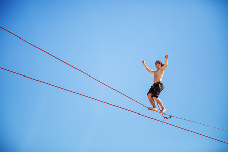 KAROLINO-BUGAZ, UKRAINE - AUGUST 24. Highline walker participating in competition at extreme sports...