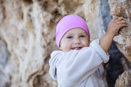 Closeup of little girl gripping cliffの写真素材