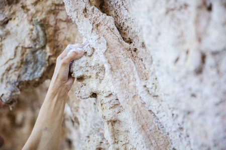 Close up of climber's hand on cliff