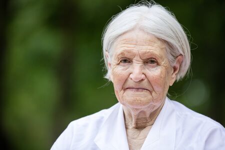 Portrait of smiling senior woman outdoors looking at camera
