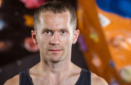 Closeup portrait of rock climber in indoor climbing gymの写真素材