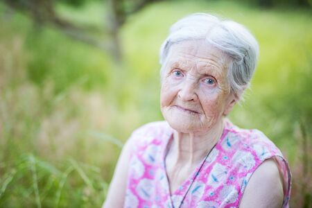 Closeup portrait of senior woman outdoors