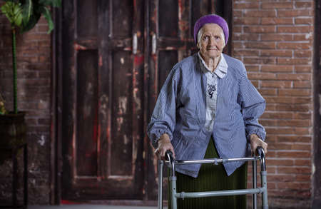 Portrait of Caucasian senior woman with walker indoorsの写真素材