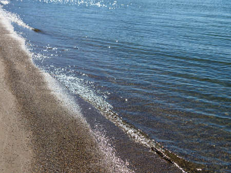 Waves crashing on the sandy beach