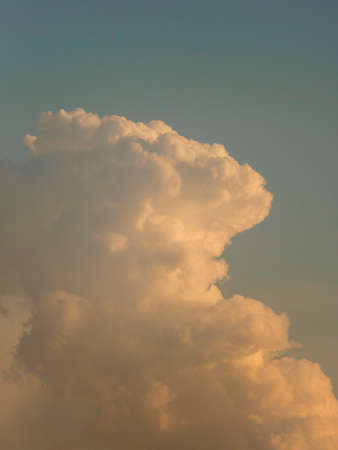 cumulonimbus clouds illuminated by the setting sunの写真素材