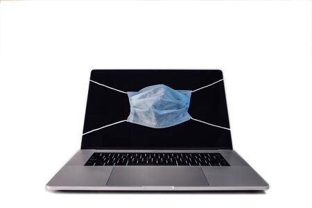 MacBook like laptop with face mask showing epidemic protect