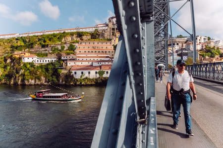 Porto, Portugal - MAY 2019: Walking through Porto Bridge with river ship and walking roadのeditorial素材