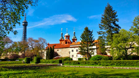 Petrin hill tower with surrounding houses and park during beautiful spring weather. One of the...