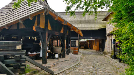 Ostra, Czech Republic - June 6, 2021: Street with cobblestones and medieval houses in front of the viewer. There is some kind of barn in the background.のeditorial素材