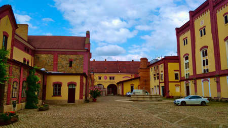 TREBON, CZECH REPUBLIC - JULY 20, 2021: Old reconstructed brewery building with entrance into the storage backyard during nice summer weather.のeditorial素材