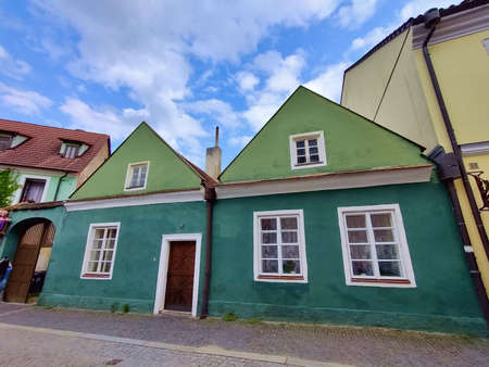 Trebon, Czech Republic - July 20, 2021: Traditional green medieval municipal houses in old small town's city center during beautiful summer weather.のeditorial素材