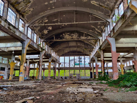 Abandoned factory building seeing from inside made of steel and concrete with missing windows. There...
