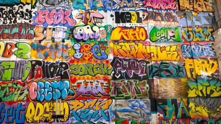 Gdansk, Poland - August 26, 2021: A lot of artistic graffiti paintings on the indoor wall of an old warehouse.のeditorial素材