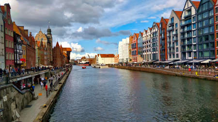 GDANSK, POLAND - AUGUST 26, 2021: A cove in the Gdansk city center with waterfront on each side. There are old traditional buildings on the left side and new modern buildings on the right side.のeditorial素材
