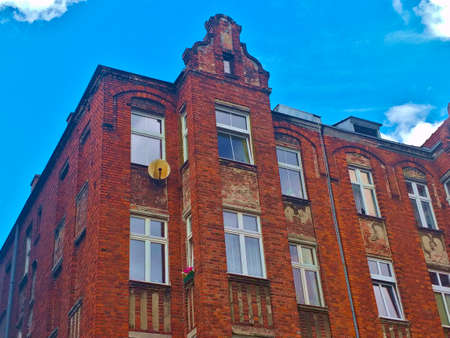 Gdansk, Poland - August 26, 2021: Detail of the upper part of an old brick style apartment building...