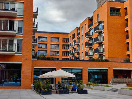 GDANSK, POLAND - AUGUST 26, 2021: Modern style apartment building in the Gdansk city center with facade made of orange bricks.のeditorial素材