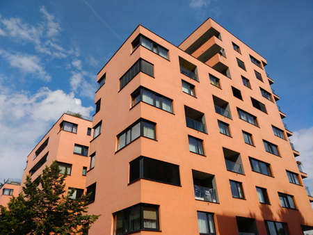 Prague, Czech Republic - September 12, 2021: Newly built residential houses in Prague's Holesovice district. The buildings are light orange and blue sky sits as a background.のeditorial素材