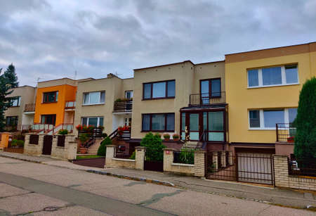 Kladno, Czech Republic - September 19, 2021: Terraced houses with small garden in front of them during cloudy day.のeditorial素材