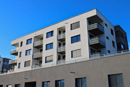Prague, Czech Republic - January 22, 2022: Apartment building with gray facade with blue clear sky...