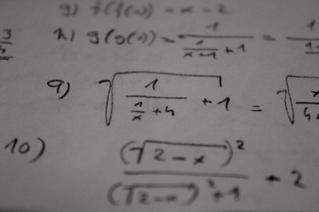 Detail of handwritten mathematical functions made of square root or linear functions. It's written on white paper.の写真素材