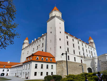 Bratislava, Slovakia - April 13, 2022: Bratislava castle seen from the corner with beautiful blue...