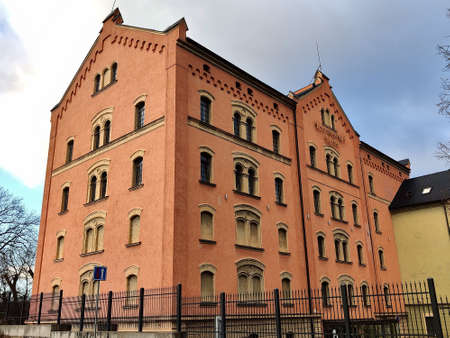 Pilsen, Czech Republic - December 20, 2021: Huge historical granary building with red facade.