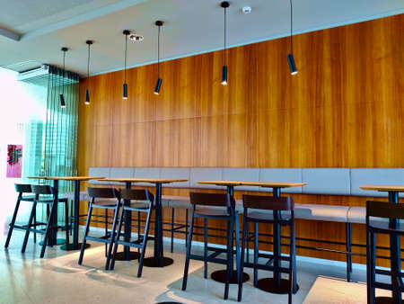 Prague, Czech Republic - November 5, 2021: Empty corner of the restaurant with high seats and tables...